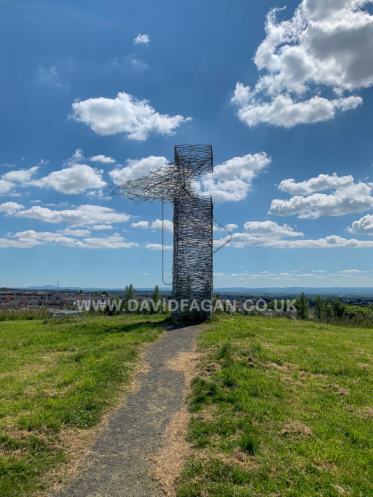 The openwork sculpture on the hilltop with a wide view across the city beyond